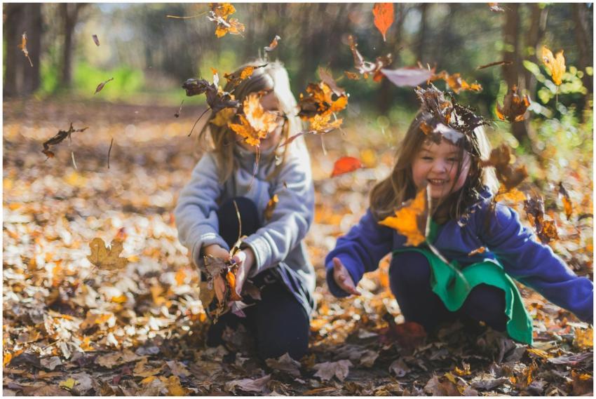 Two smiling girls playing joyfully amidst colorful