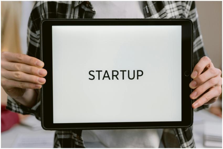 Person holding a digital tablet displaying the wor