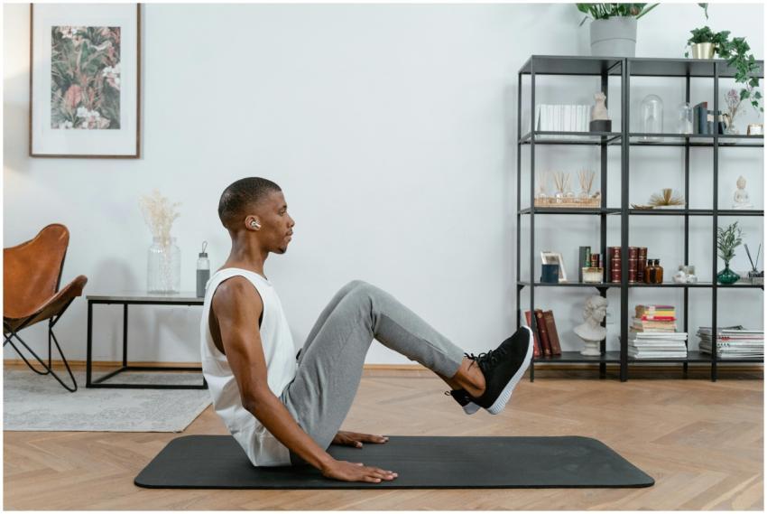 An African American man practicing yoga indoors on