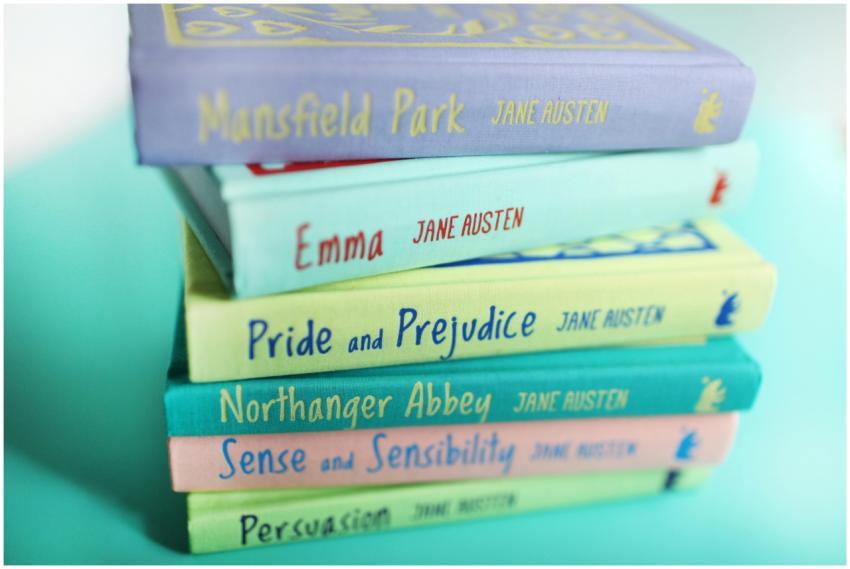 A vibrant stack of Jane Austen books against a pas