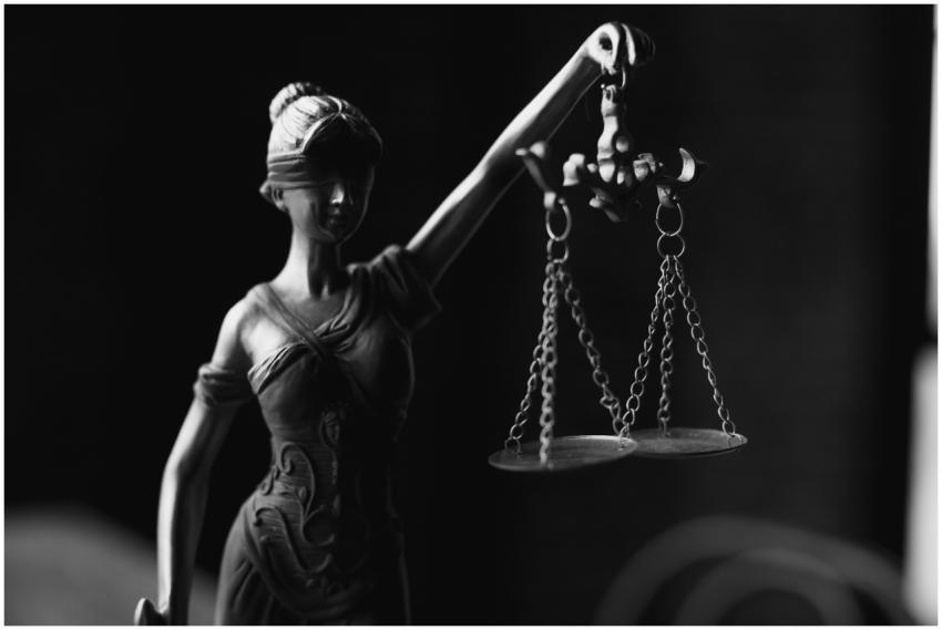 A close-up black and white photo of the Lady Justi