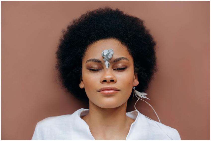 A serene woman practicing mindfulness with a heali