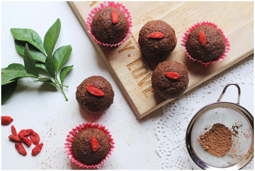 Tasty chocolate cupcakes topped with goji berries,