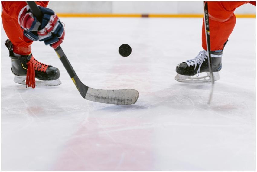 Dynamic ice hockey faceoff with players battling f
