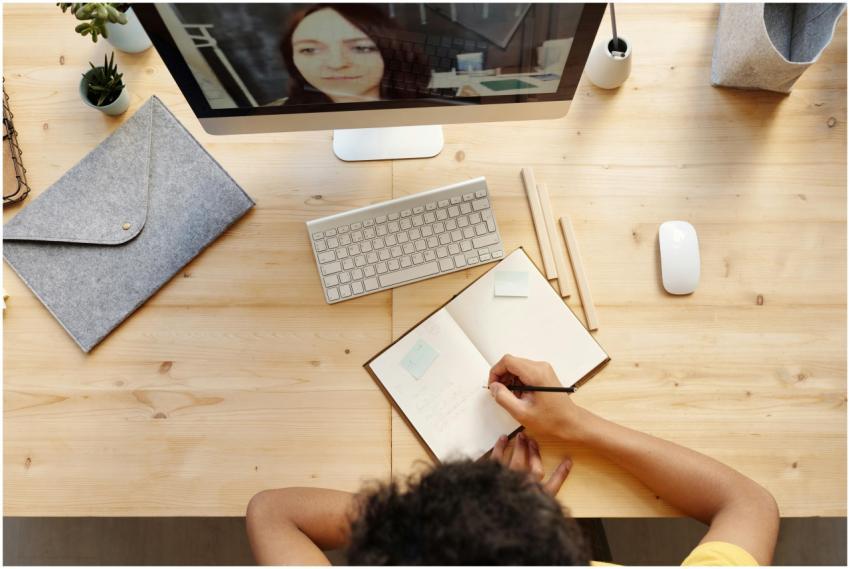 A teenager studying at home using a computer for o