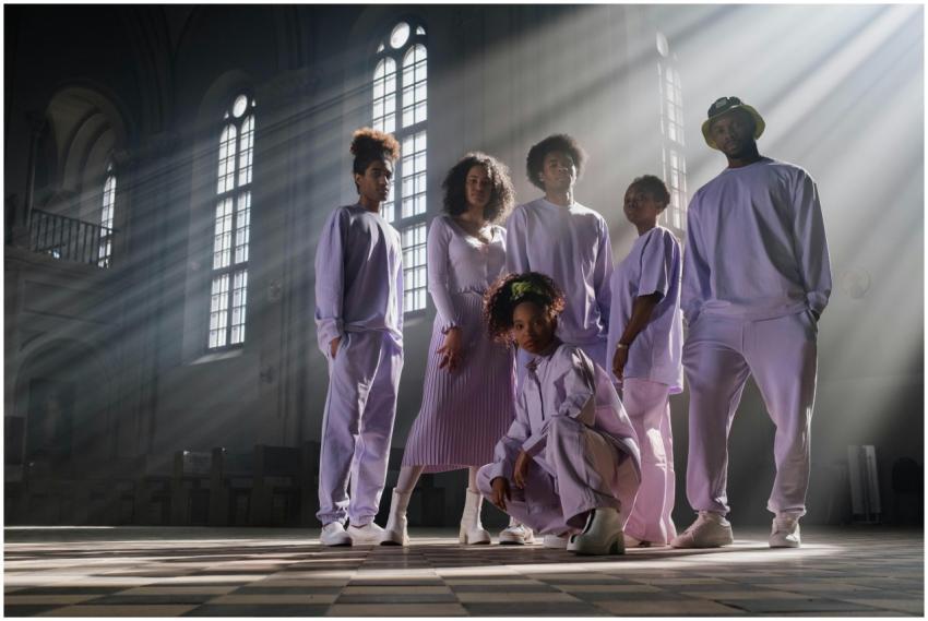 A fashionable group in pastel attire posing dramat