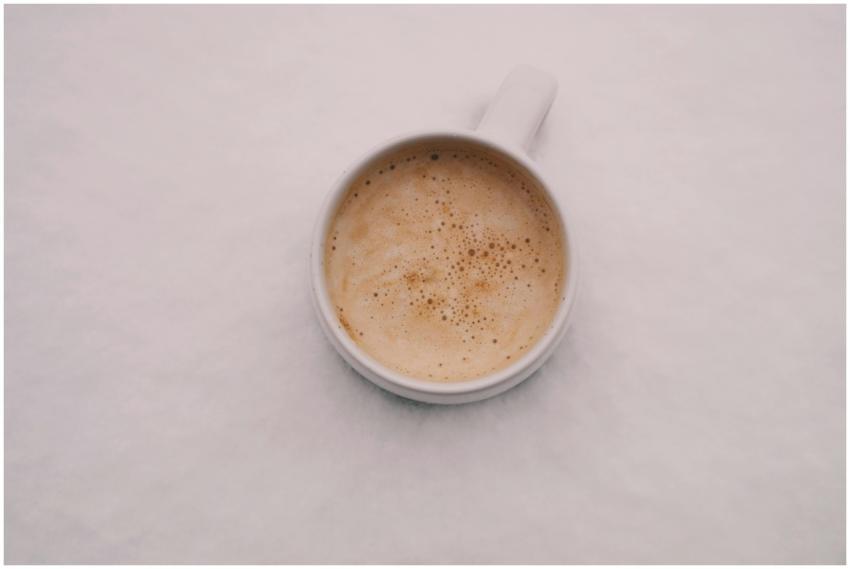 Aerial view of a creamy cappuccino in a white mug,