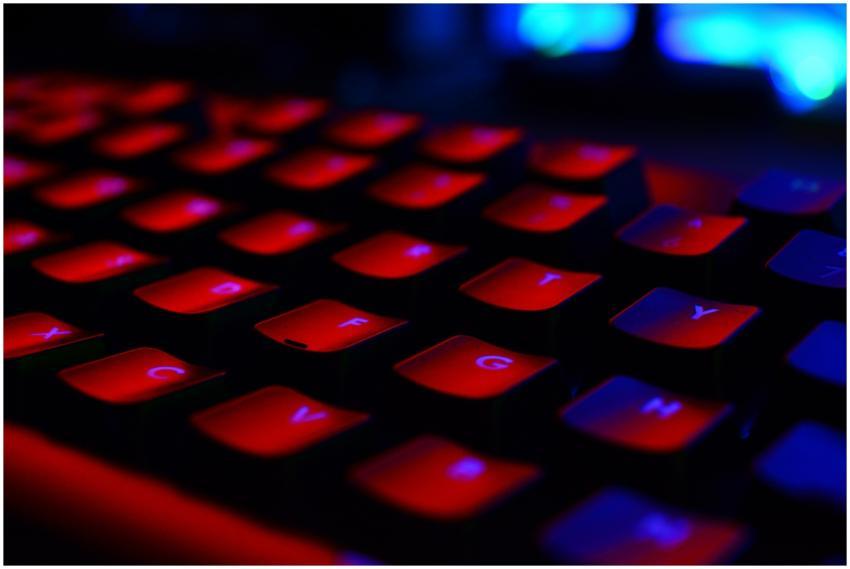 Close-up of a red backlit keyboard, highlighting t