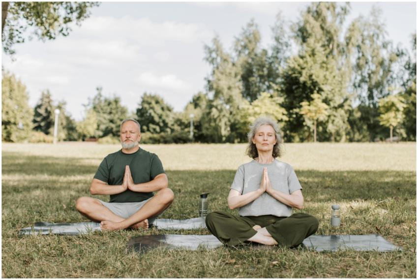 Senior couple meditating on yoga mats in a serene