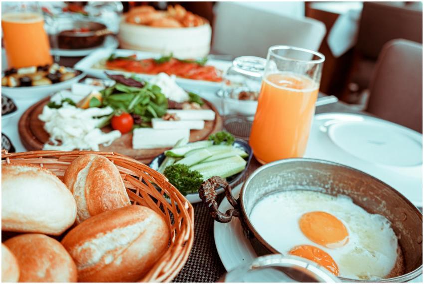 Appetizing breakfast table with orange juice, frie