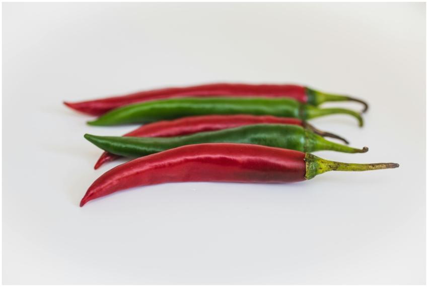 A close-up view of fresh red and green chili peppe