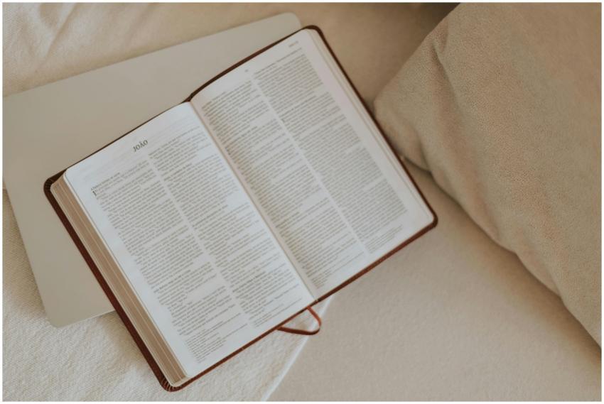 An open Bible on a beige blanket, inviting peacefu