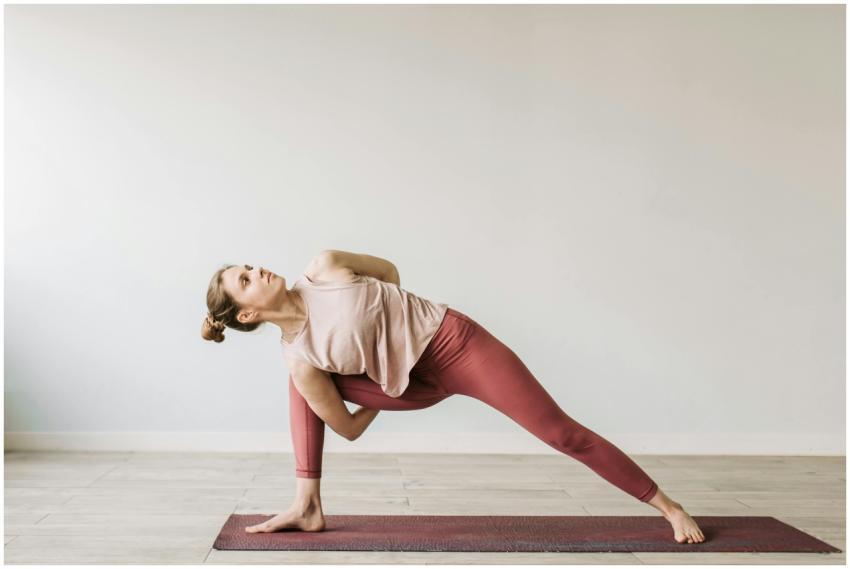 A woman practicing a yoga pose indoors on a mat, s