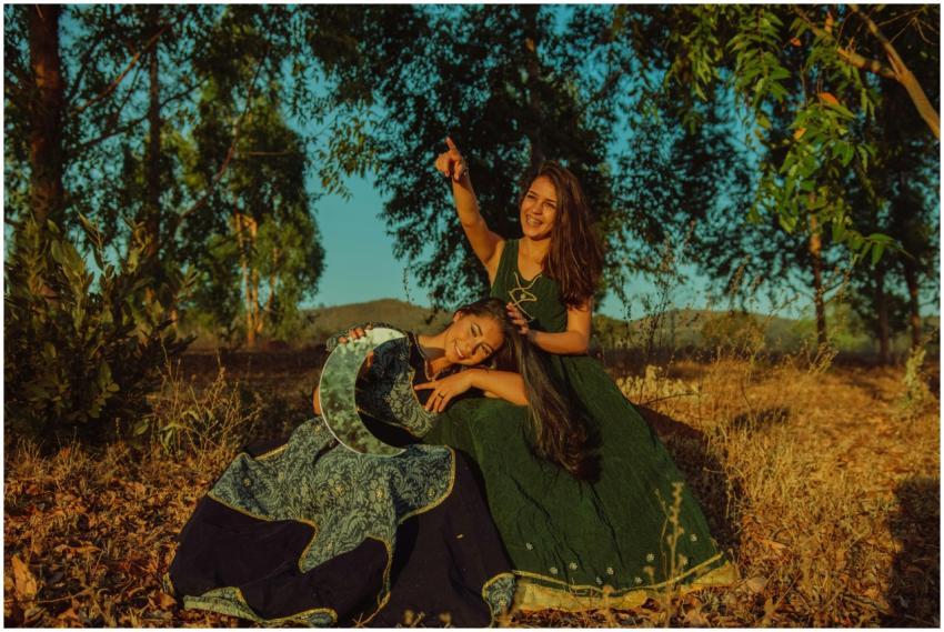 Two women in traditional attire enjoy the outdoors