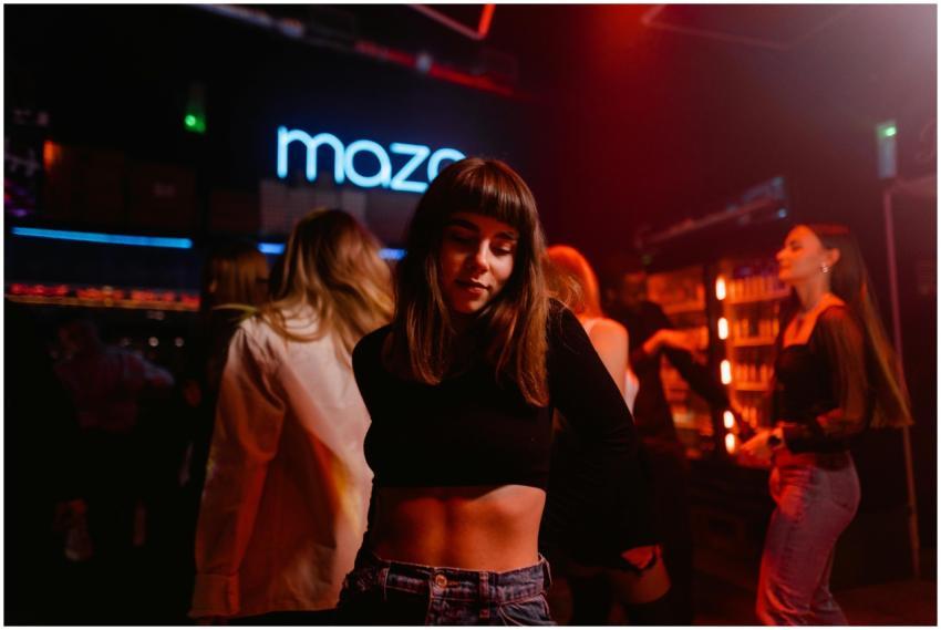 Woman dancing at a lively nightclub with friends i