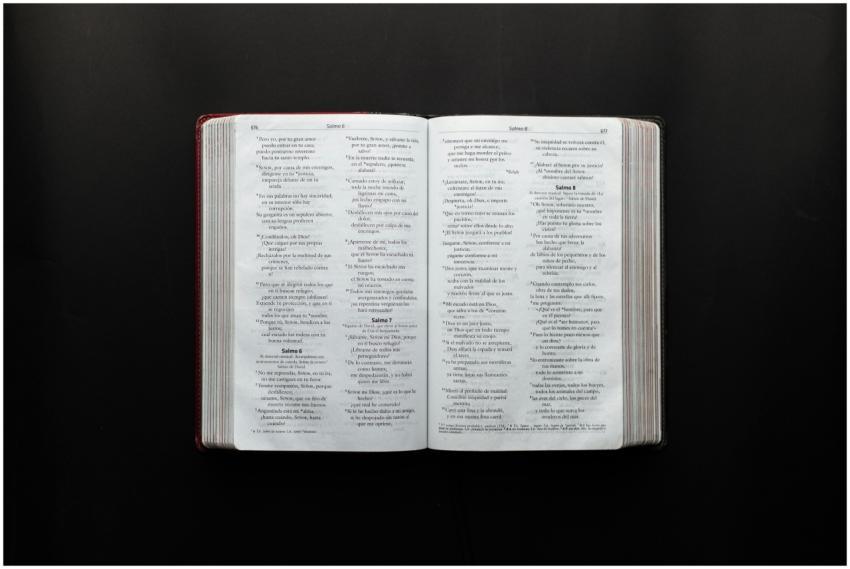 Open Bible displaying Psalms on a dark surface for