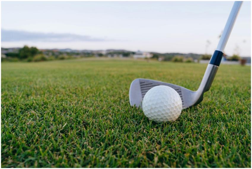 Golf ball with club on lush green grass, perfect f