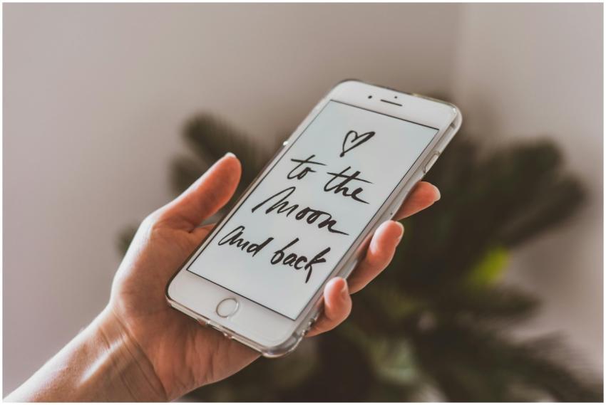 A hand holding a smartphone displaying an inspirat