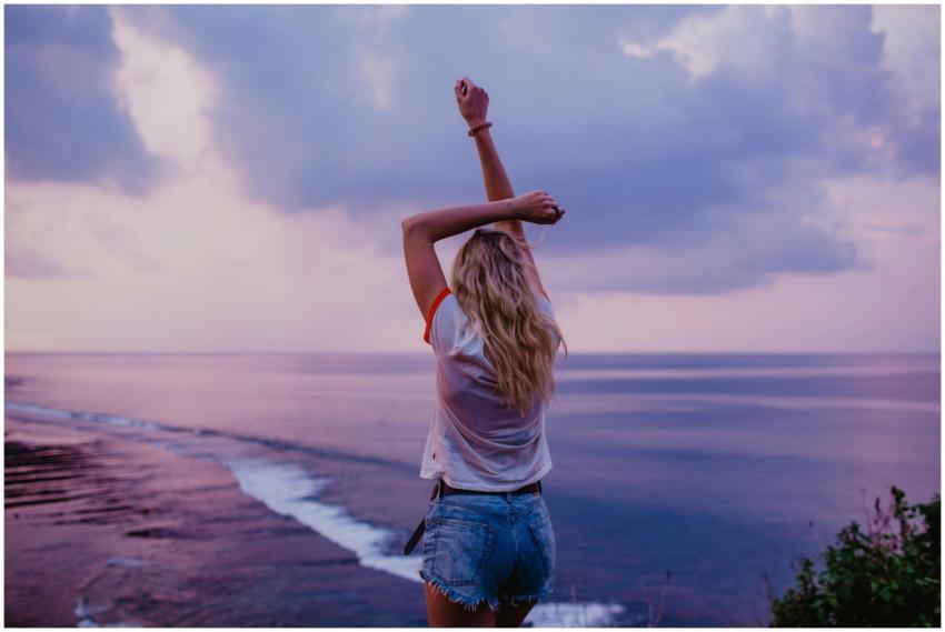 Back view anonymous female in denim shorts and whi