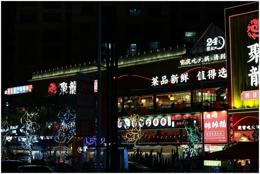 Colorful neon-lit street market bustling with nigh