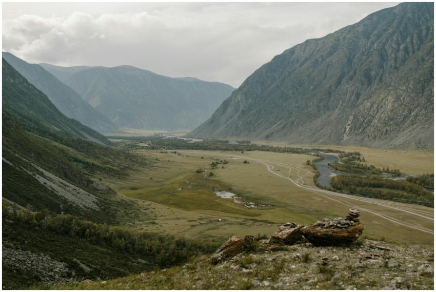 Stunning view of a peaceful valley surrounded by t