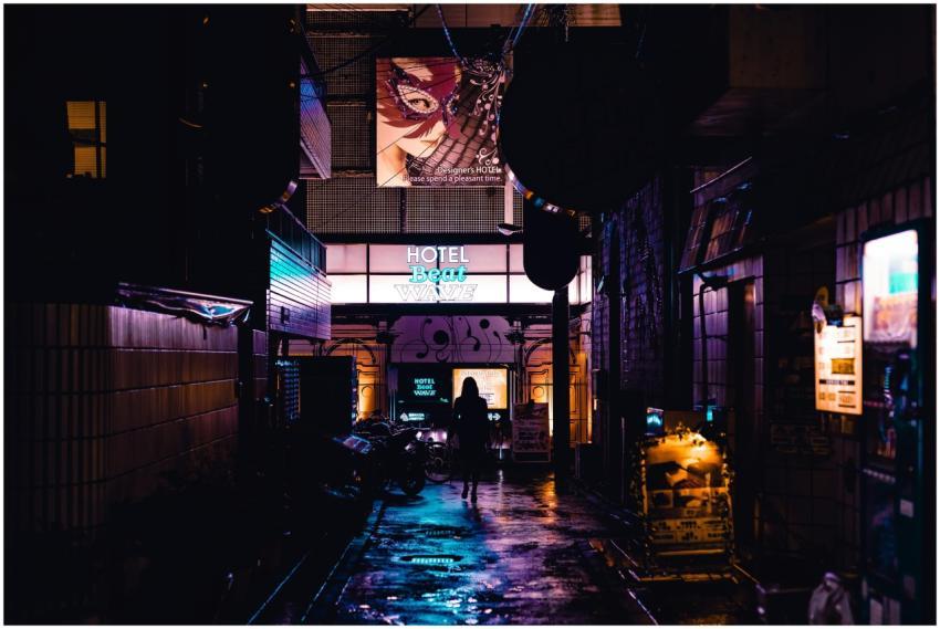 Silhouette of a person walking in a vibrant, neon-