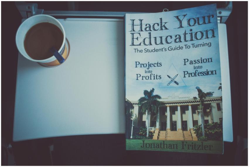 A book and cup of coffee on a tray table, promotin