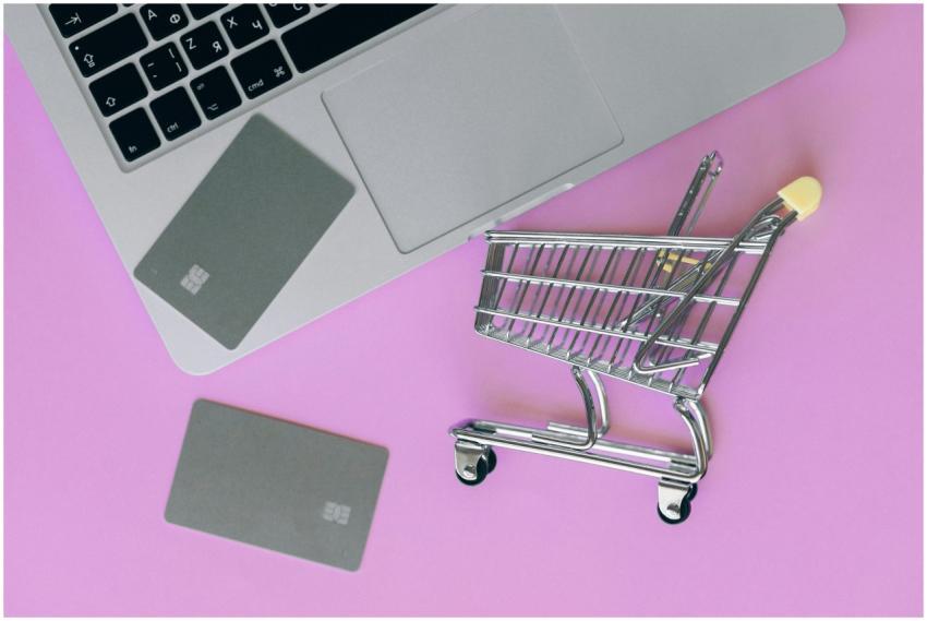 A minimalist flat lay of a credit card, laptop, an