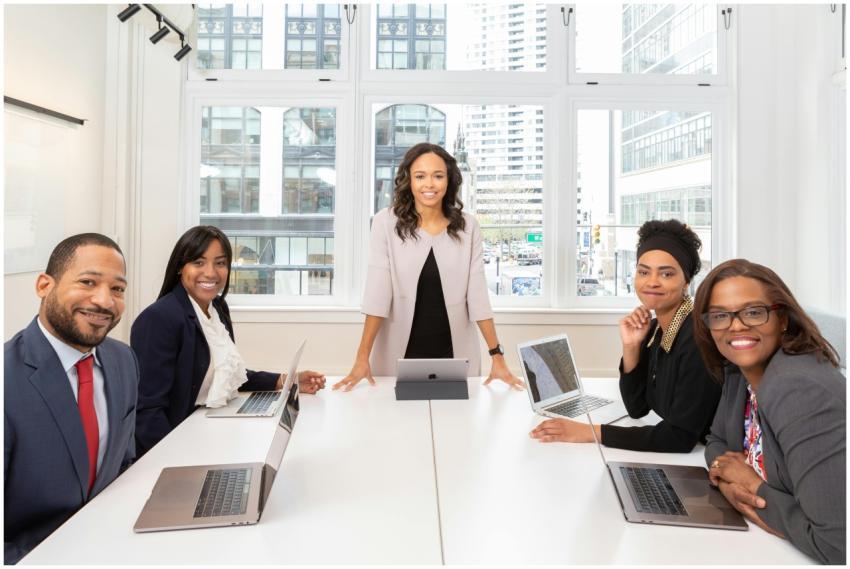 Multicultural team collaborating in boardroom with