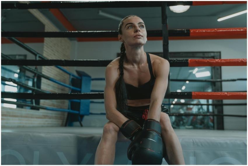A female boxer in activewear takes a break in the