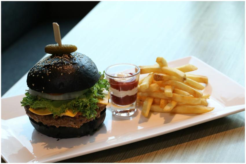 Mouthwatering charcoal burger with cheese and frie