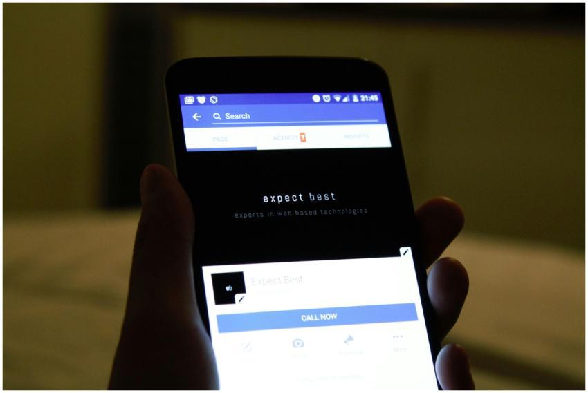 Close-up of a hand holding a smartphone showing a