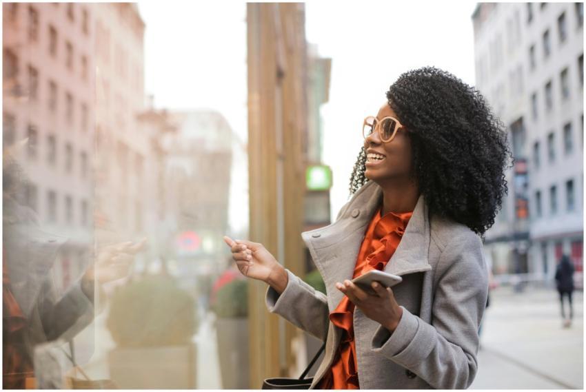 Happy woman with curly hair shopping in the city,