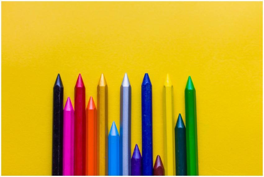 Close-up of colorful crayons arranged on a bright