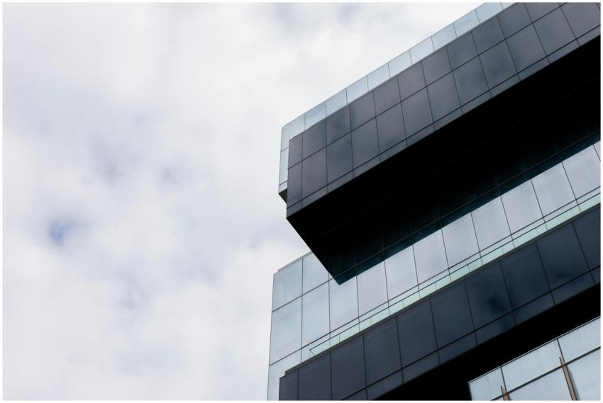Low angle view of a modern skyscraper with glass f