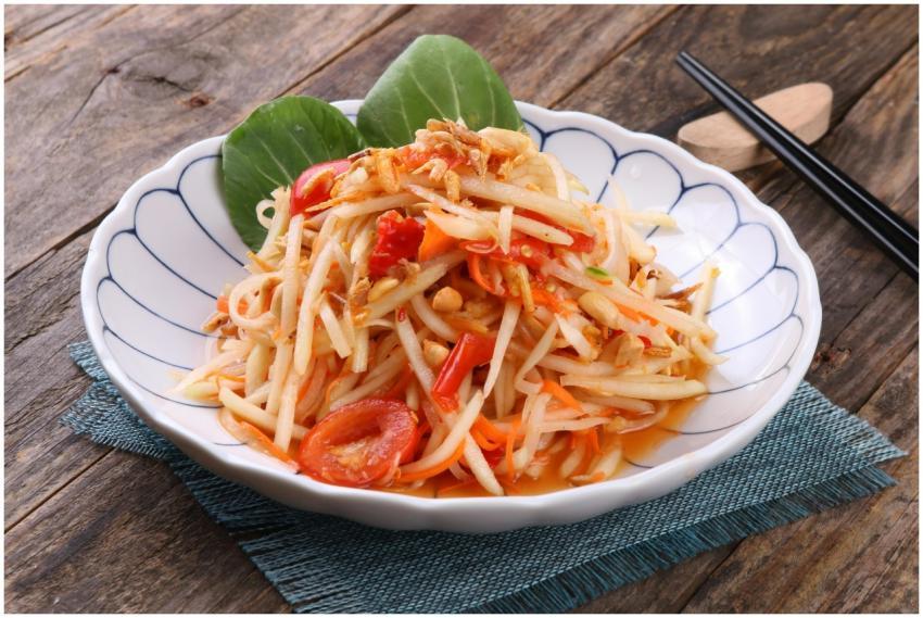A flavorful Thai green papaya salad on rustic wood