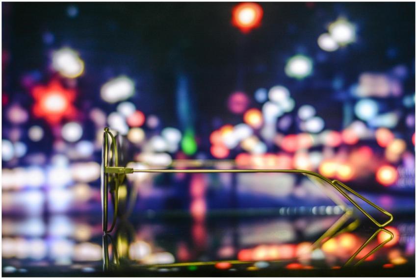 Stylish golden glasses with colorful bokeh of Dhak