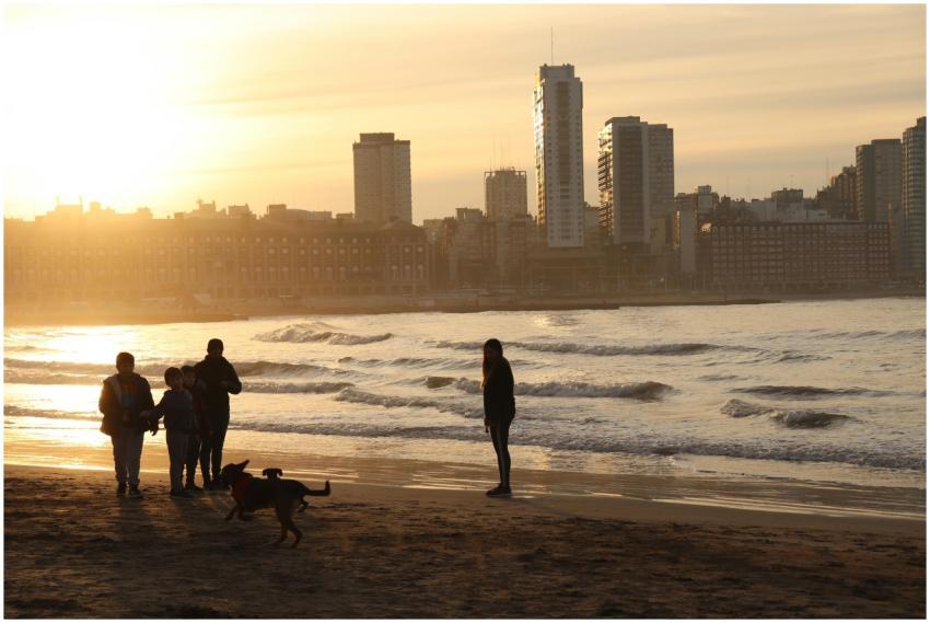 Family enjoying a sunset walk on Mar del Plata bea