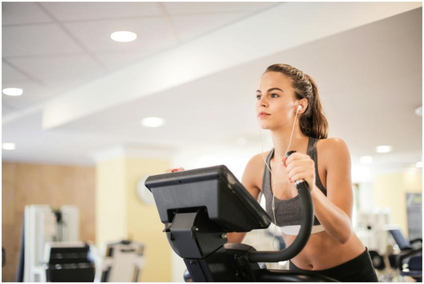 Woman in a gym focused on cardio exercise using el