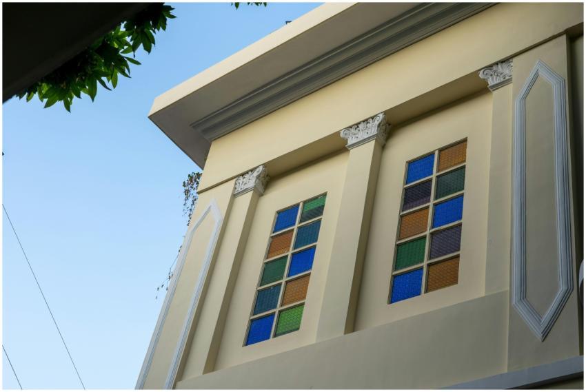 An elegant building facade with colorful stained g