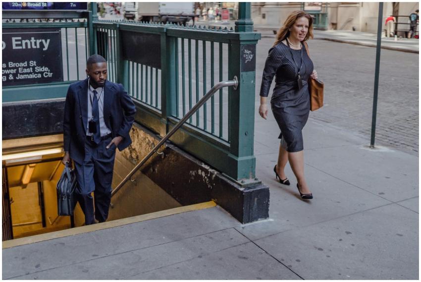 Professional man and woman on a busy city street n