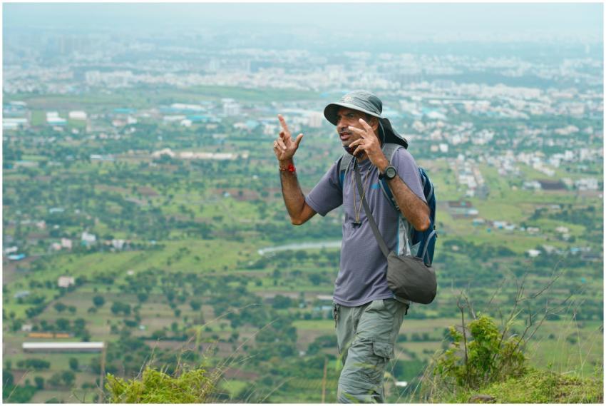Man on a hike with a beautiful view of Pune city i