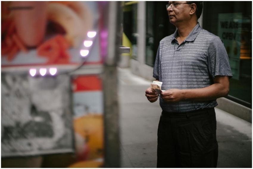Crop male customer with banknotes in eyeglasses ma