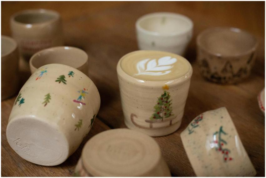 Handcrafted ceramic coffee cups with festive Chris
