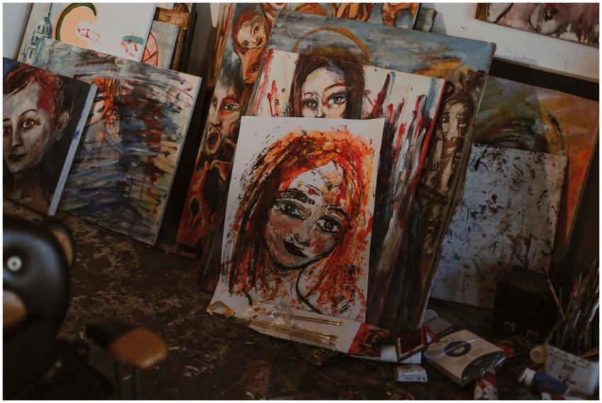 A creative art studio with colorful paintings of d