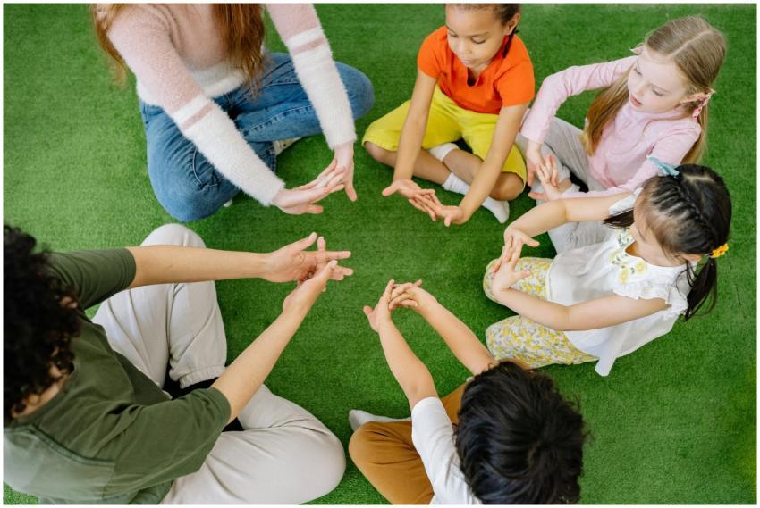 A group of diverse children sit in a circle, engag