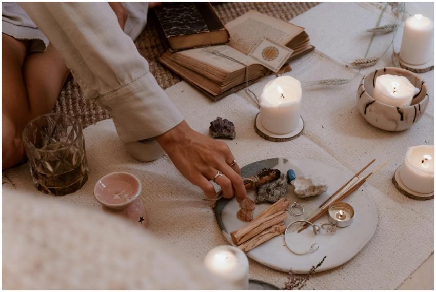 A peaceful ritual scene with candles, crystals, an