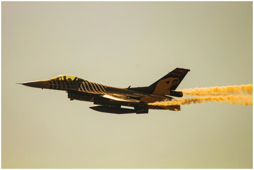 F-16 fighter jet performing an aerial maneuver lea