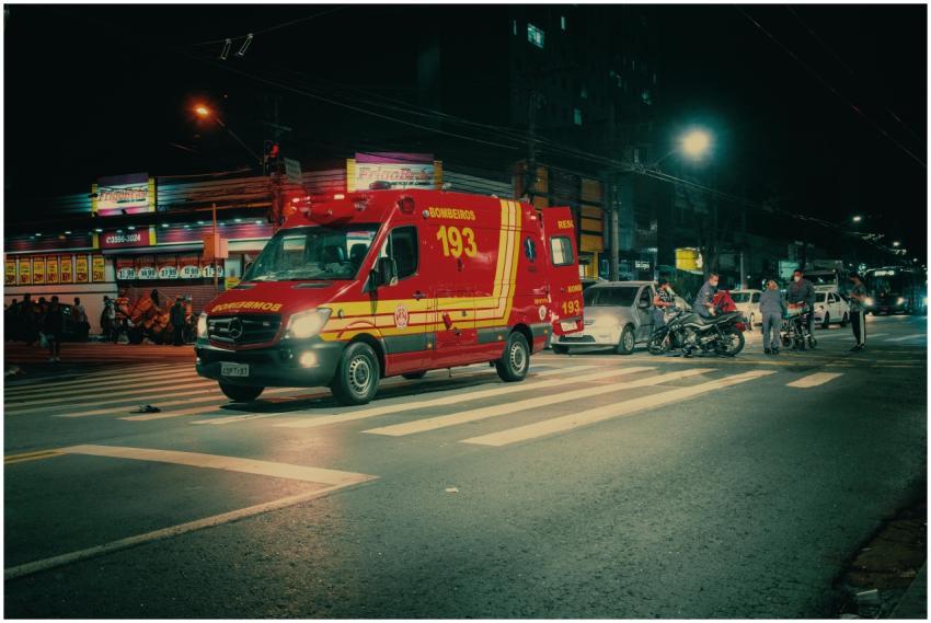 Red emergency transport near  car crash on illumin