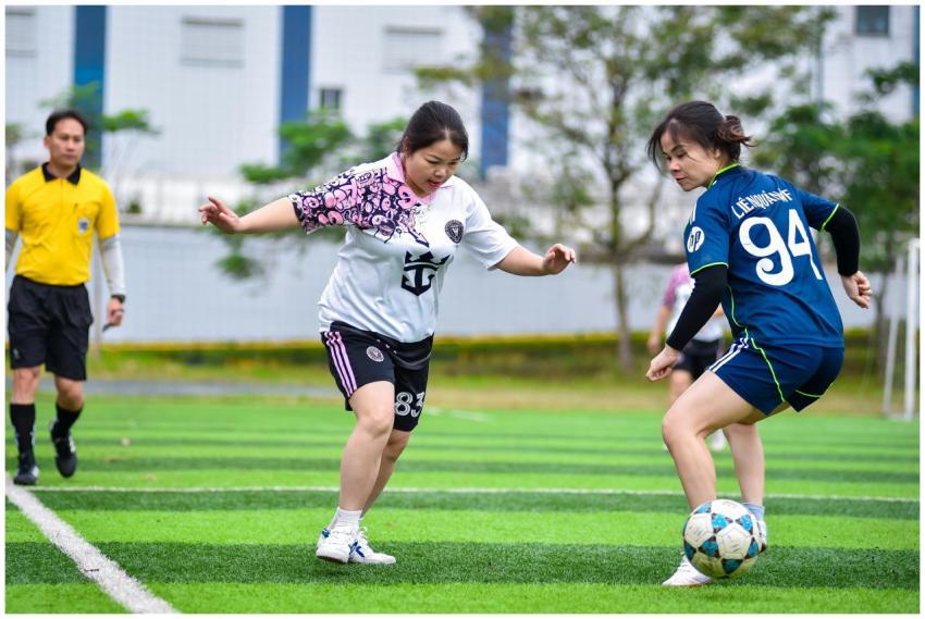 Women playing a competitive football match outdoor